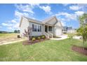 Beautifully landscaped yard complements this inviting one-story home with attached garage at 152 Royal Ave, Selma, NC 27576