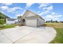 Well-maintained home boasts a spacious driveway and an attached two-car garage at 152 Royal Ave, Selma, NC 27576