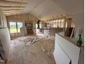 Interior shows an unfinished home with wood frame, insulation and a construction worker at 152 Royal Ave, Selma, NC 27576