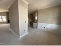 Bright living room with decorative trim and an open floor plan that connects to the kitchen at 152 Royal Ave, Selma, NC 27576