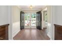 Inviting foyer with hardwood floors, decorative molding, and grand double doors leading to the outside at 1602 Lake Shore Dr, Dunn, NC 28334