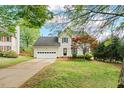 Charming home featuring manicured landscaping, a driveway, and an attached garage at 1604 Cane Creek Dr, Garner, NC 27529