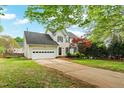 A home with a well-kept lawn, attached garage, and a traditional design at 1604 Cane Creek Dr, Garner, NC 27529