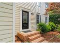 Close-up of a home's entrance featuring a decorative door and brick steps at 1604 Cane Creek Dr, Garner, NC 27529