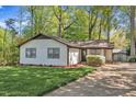 Quaint single-story home with a well-kept lawn, a simple shrub and a long driveway at 1623 Alicary Ct, Cary, NC 27511