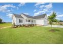 Charming single-Gathering home featuring a well-manicured lawn, inviting porch, and attached garage at 172 Royal Ave, Selma, NC 27576