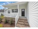 Inviting front porch featuring brick steps, white railing, and view of manicured lawn at 172 Royal Ave, Selma, NC 27576