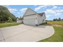 Spacious two-car garage featuring white doors, exterior lighting, and concrete driveway at 172 Royal Ave, Selma, NC 27576