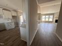 Bright kitchen featuring white cabinets, granite countertops, and stylish backsplash at 172 Royal Ave, Selma, NC 27576