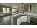 Modern kitchen boasts granite countertops, white cabinets, and an open view to the living room at 172 Royal Ave, Selma, NC 27576