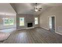 Spacious living room with fireplace, high ceilings and light wood flooring at 192 Royal Ave, Selma, NC 27576