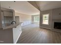 Open-concept living room with breakfast bar, chair railing, and bright natural light at 192 Royal Ave, Selma, NC 27576