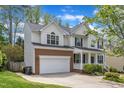 Traditional two-story home featuring a brick-accented garage and manicured landscaping at 2002 Patapsco Dr, Apex, NC 27523
