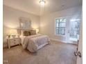 Cozy bedroom featuring a comfortable bed, soft carpet, and a door leading to the outdoor area at 221 Pond View Ct # 9, Fuquay Varina, NC 27526