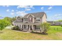 Charming two-story home features a covered front porch and well-manicured lawn, creating an inviting curb appeal at 24 Kaki Ct, Selma, NC 27576