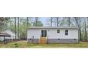 Rear view of house showing sliding glass door leading to backyard with stairs at 25 Beechnut Ct, Franklinton, NC 27525