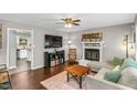 Comfortable living room with a fireplace, hardwood floors, and a cozy sectional sofa at 2700 Ross Rd, Durham, NC 27703