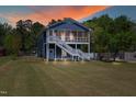 Charming two-story home with a screened-in porch under beautiful colorful skies at 283 Raynor Rd, Spring Lake, NC 28390