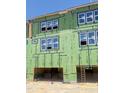 Townhome under construction featuring weather barrier, and windows at 3020 White Rail Dr, Fuquay Varina, NC 27526