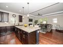 Open-concept kitchen and living room with hardwood floors, granite countertops, and cozy fireplace at 3029 Willow Ranch Dr, Fuquay Varina, NC 27526