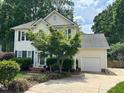 Well-kept two-story home with attached garage, complemented by mature trees at 3100 Benton Cir, Raleigh, NC 27615