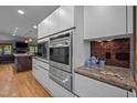 Contemporary kitchen design with built-in stainless appliances, modern cabinetry, and decorative backsplash at 33 Stoneridge Cir, Durham, NC 27705