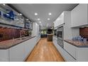 Sleek, modern kitchen featuring stainless steel appliances, custom cabinets, and a stylish backsplash at 33 Stoneridge Cir, Durham, NC 27705