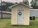 Small storage shed with a decorative wreath on the door at 335 Ashley Ave, Timberlake, NC 27583