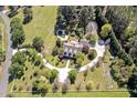 Expansive aerial view of a secluded estate showcasing lush landscaping and a winding driveway at 40 Farrells Creek Rd, Apex, NC 27523