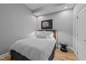Cozy bedroom with light gray walls, hardwood floors, and a comfortable bed with a decorative painting at 400 W North St # 1420, Raleigh, NC 27603