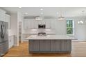 Modern kitchen with a large island, stainless steel appliances, and plenty of counter space at 4897 Grosbeak Ct, Mebane, NC 27302