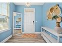 Light and bright foyer with wood floors, a large mirror, and decorative wall hangings at 509 Rose Creek Ct, Zebulon, NC 27597