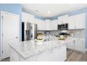 Modern kitchen with white cabinets, stainless steel appliances, and granite countertops at 509 Rose Creek Ct, Zebulon, NC 27597