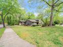 Beautiful home featuring an attached garage, front porch, landscaping, and a lush green lawn at 5816 Old Forge Cir, Raleigh, NC 27609