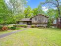 Lovely home featuring neatly trimmed shrubs, a walkway, and a freshly manicured front yard at 5816 Old Forge Cir, Raleigh, NC 27609