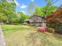 Inviting two-story home with colorful landscaping, shrubs, and flowering trees in the front yard at 5816 Old Forge Cir, Raleigh, NC 27609