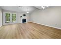 Bright living room with vaulted ceiling, fireplace, and access to the outdoor at 65 Forest Oaks Dr, Durham, NC 27705