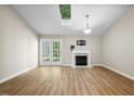 Bright living room with vaulted ceiling, fireplace, and access to the outdoor at 65 Forest Oaks Dr, Durham, NC 27705