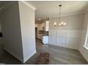 Open-concept dining room area featuring gray flooring and a modern chandelier at 69 Tee Dr, Selma, NC 27576