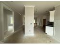 Open floor plan showcasing the home's unfinished interior with a view of the kitchen and living spaces at 69 Tee Dr, Selma, NC 27576