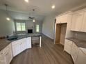 Bright kitchen with white cabinets, granite countertops, and stainless steel appliances at 69 Tee Dr, Selma, NC 27576