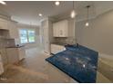 Modern kitchen with white cabinets, granite countertops and stainless steel sink at 69 Tee Dr, Selma, NC 27576