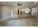 Open-concept living area adjacent to kitchen, featuring a ceiling fan and natural light at 69 Tee Dr, Selma, NC 27576