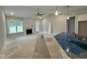 Open-concept living room with a fireplace, high ceilings, and lots of natural light at 69 Tee Dr, Selma, NC 27576