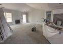 Spacious living room with a fireplace, bright windows, and elegant trim, perfect for comfortable living at 69 Tee Dr, Selma, NC 27576