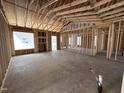 Open-concept living room with exposed framing, showcasing the layout and potential for customization in the new home at 69 Tee Dr, Selma, NC 27576