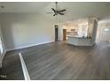 Spacious living room with gray flooring, leading into the kitchen area at 69 Tee Dr, Selma, NC 27576