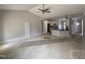 Open-concept living space showcasing the kitchen, a ceiling fan, and an entryway, all awaiting completion at 69 Tee Dr, Selma, NC 27576