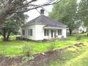 Quaint one-story home with covered porch and a well-manicured lawn in a serene neighborhood at 702 Mill St, Wake Forest, NC 27587