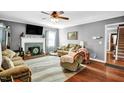 Cozy living room with hardwood floors, a decorative fireplace, and comfortable seating at 708 W Pope St, Dunn, NC 28334